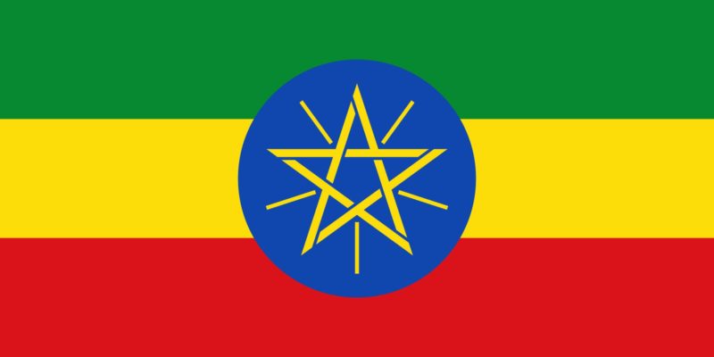 Flag of Ethiopia: green, gold, and red tricolour with a golden pentagram on a blue disc superimposed at the centre.