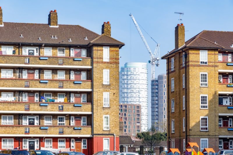 Image of housing blocks with more modern blocks in construction in the background