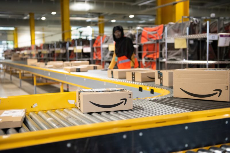 Image of Amazon packages on conveyor belt in factory
