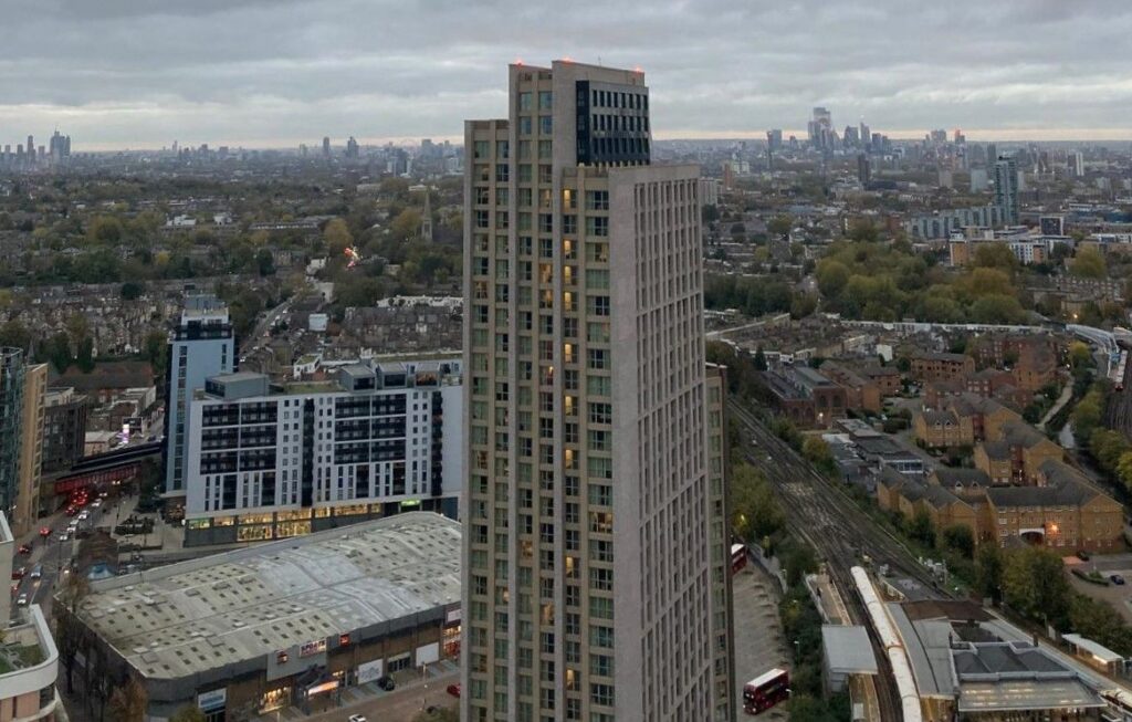 Photo of Lewisham North skyline on a cloudy day. A tower block is in the centre of frame and others can be seen on the horizon.